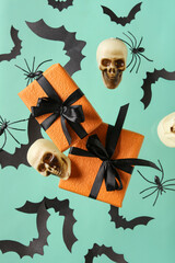 Wall Mural - Flying gift boxes, paper bats, spiders and skulls for Halloween celebration on turquoise background