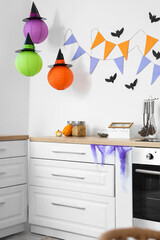 Sticker - Interior of light kitchen decorated for Halloween with white counters and pumpkins