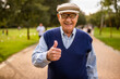 © djoronimo - Portrait of happy senior man in park. He is relaxing and walking.