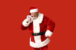 © Pixel-Shot - Santa Claus in sunglasses on red background