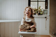 © Halfpoint - Portrait of an adorable little girl sitting on wooden stool, sticking out tongue.