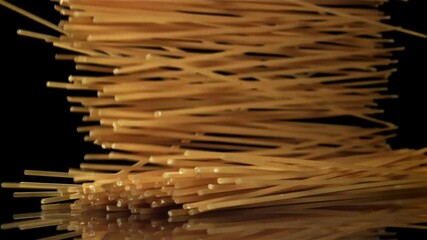 Sticker - Dry spaghetti falling on a black background. Filmed on a high-speed camera at 1000 fps. High quality FullHD footage