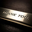 © Deepa - 'Thank You' text engraved on a metallic plaque with a dark background, conveying a formal and elegant tone