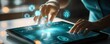 © Aris Suwanmalee - A person interacting with a futuristic tablet, displaying holographic data and technology in an engaging digital environment.