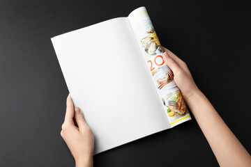 Poster - Woman reading magazine on black background, closeup. Mockup for design