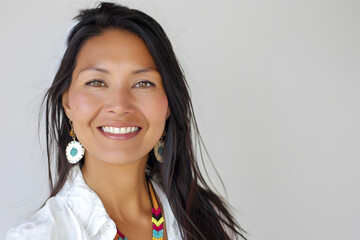 Portrait of native American smiling woman wearing traditional Indian jewelry isolated on white background