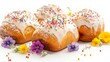 © fivan - Brioche with vanilla icing and sprinkles, isolated on a white background with decorative edible flowers and powdered sugar