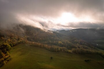 Misty mountain landscape with autumn foliage