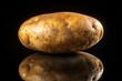 © Sathaporn Buarabut - Oversized potato isolated on black background with depth of field