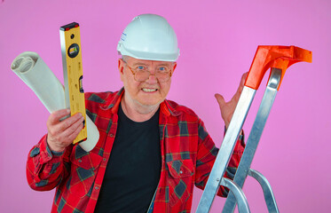 Elderly man, builder with drawings in his hands. Pink background.