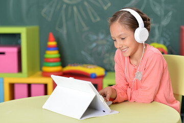 cute little woman with tablet and headphones