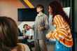 © Jacob Lund - Generation Z group task in a modern office setting with young professionals giving a presentation to their team members