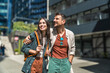 © Srdjan - Young happy couple in love waiting for their real estate agent to give them the tour of their new apartment to buy or for rent. Man and woman wait outside residential building of their new home.