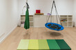 © Jordi Mora - Sensory integration therapy room with swings and mats for children