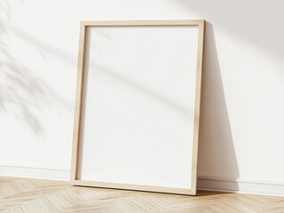 A wooden picture frame leaning against a white wall, casting shadows.