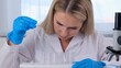 © Евгения Медведева - Close up research chemist takes samples for research and works in a laboratory with a micropipette and a microscope.