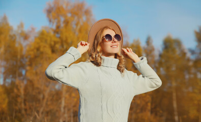 Wall Mural - Happy stylish smiling woman in autumn park, joyful girl enjoying warm sunny weather, fall season