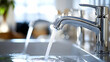 © Siasart Studio - Close-up of a kitchen faucet with flowing water.