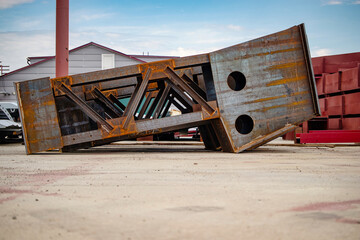 Metal structures stored at an industrial site, showcasing heavy fabrication and materials ready for future projects during a clear day