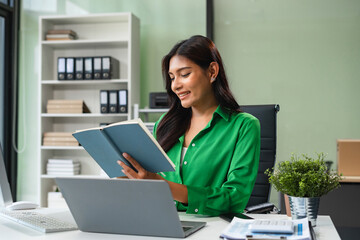 Business woman hand working with tablet and laptop computer with documents on office desk in modern office.