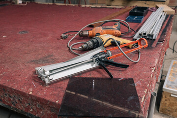 A cluttered workshop, scattered tools, and materials, used for crystal polishing