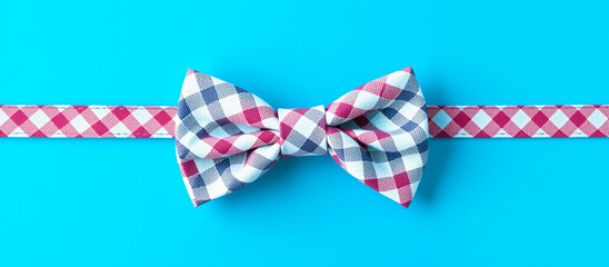 red blue checkered bow tie with matching ribbon on a bright blue background