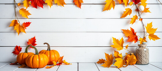 Canvas Print - three pumpkins adorned with autumn leaves on a white wooden surface