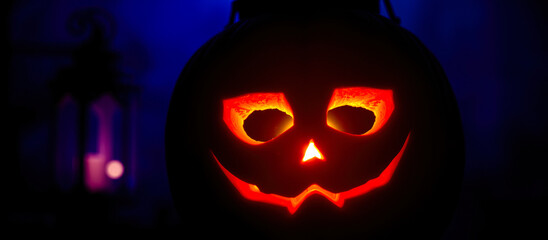 Wall Mural - glowing carved pumpkin with a wide grin