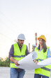 © Ljustina - Two engineers reading blueprints on construction site