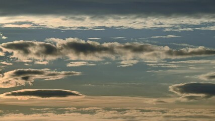 Wall Mural - time lapse early evening light blue sky with layers of clouds moving at different speeds