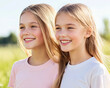 © AIPhoto - Smiling girls enjoying sunny day outdoors, sharing joyful moment in grassy field. Their happiness and friendship are evident in this beautiful setting