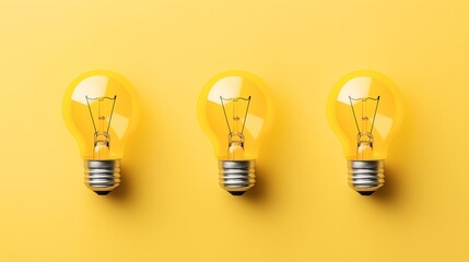 Wall Mural - Three incandescent light bulbs arranged in a row on a yellow background, creating a minimalist and vibrant composition.