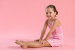© New Africa - Portrait of little ballerina on pink background