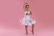 © New Africa - Little ballerina practicing dance moves on pink background