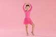 © New Africa - Little ballerina practicing dance moves on pink background