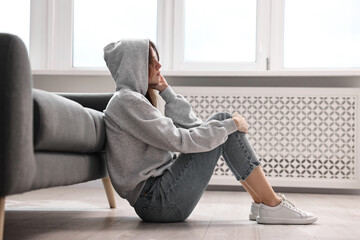 Loneliness concept. Teenage girl on floor at home