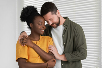 Wall Mural - International relationships. Portrait of lovely couple at home