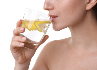 Wall Mural - Woman drinking water with lemon on white background, closeup