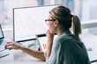 © BullRun - Focused businesswoman watching graphs on laptop