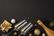 © ActionGP - A classy top view new year celebration setup with champagne, two glasses, a gift box, and sparkling decorations on a dark background