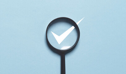 Fototapete - White correct sign mark inside of magnifier glass for focus on project and document approval concept.