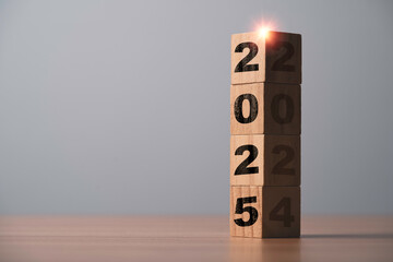 Wall Mural - 2025 on bright side and 2024 on dark side of wooden block cube for preparation of merry christmas an