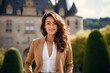 © Markus Schröder - Portrait of a smiling woman in her 20s dressed in a stylish blazer isolated on backdrop of a grand castle