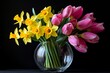 © Thanyarat - A bouquet of Narcissus and Tulips arranged in a glass vase, with the yellow Narcissus and pink Tulips creating a fresh, vibrant display of springtime beauty