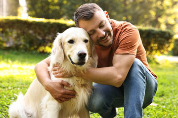 Wall Mural - Man with cute Golden Retriever dog on spring day