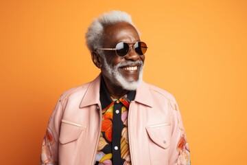 Portrait of a satisfied afro-american man in his 80s wearing a trendy bomber jacket in pastel orange background