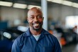 © Baba Images - Portrait of a smiling middle aged African American car mechanic
