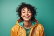 © Markus Schröder - Portrait of a happy woman in her 30s sporting a waterproof rain jacket over soft teal background