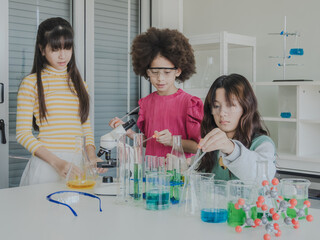 Child kid girl asian young student education tree people team group learning and smile have fun happy enjoy with science lab technology with in school classroom has tubetest microscope chemicals table