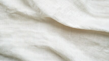 Poster - The soft white linen fabric lies gracefully on a surface, displaying its gentle folds and intricate texture under natural light
